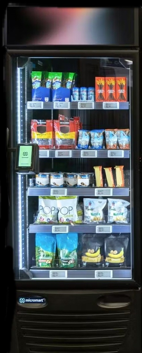 Micro mart display case stocked with snacks and beverages